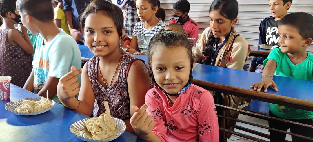 Two girls having nutritious food under Malnutrition Project by Pledge Foundation